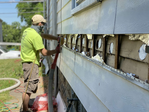 Man working on insulation outside of an Albany area home